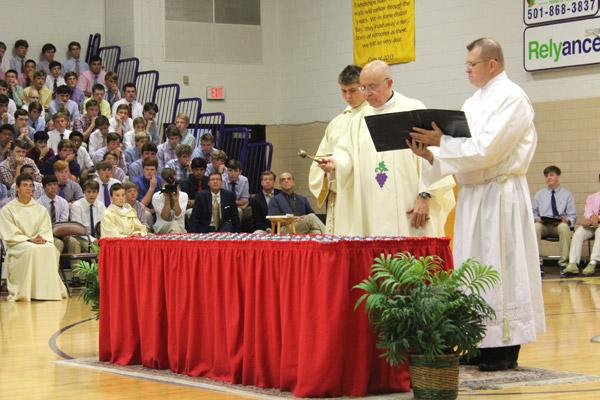 Msgr. Lawrence Frederick, CHS rector, blesses the seniors’ rings prior to distributing them at the conclusion of the annual Ring Mass. (Dwain Hebda photo)