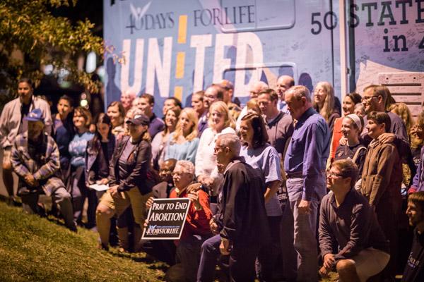 Participants in the 40 Days for Life rally gather for a group photo in front of the “50 states in 40 days” tour bus. (Travis McAfee photo)