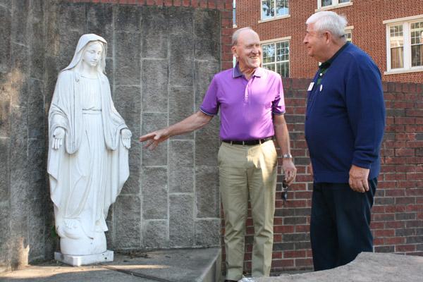 Knights of Columbus member Bob Honzik (left) and grand knight Tom Donnelly, from Sacred Heart of Jesus Church in Hot Springs Village, discuss the damage to the Virgin Mary statue Oct. 11. (Aprille Hanson photo)