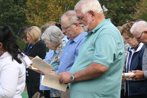 Don Pilkington (right), a member of St. Theresa Church in Little Rock, and his brother Paul Pilkington, a member of Our Lady of the Holy Souls Church in Little Rock, silently follow along as names of the deceased were read during the All Souls Day Mass. (Aprille Hanson photo)
