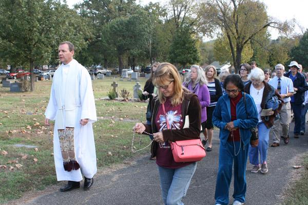Suzette Bridges, a member of St. Patrick Church in North Little Rock, walks in a rosary procession through Calvary Cemetery with other faithful following the All Souls Day Mass. (Aprille Hanson photo)