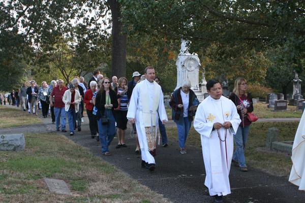 Father Erik Pohlmeier (right), director of faith formation and permanent diaconate formation in the Diocese of Little Rock, led the rosary procession through Calvary Cemetery. Father Jack Vu, rector of the Cathedral of St. Andrew, also concelebrated the All Souls Day Mass. (Aprille Hanson photo)