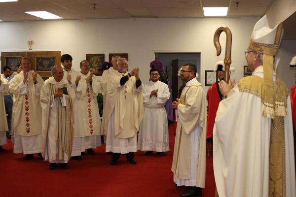 Brother seminarians, priests and Bishop Taylor cheer Deacon Rubio after being ordained a transitional deacon. (Aprille Hanson photo)