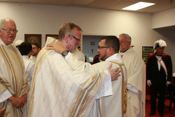 Msgr. Scott Friend, diocesan director of vocations, hugs Deacon Rubio, who he called “inspiring.” (Aprille Hanson photo)