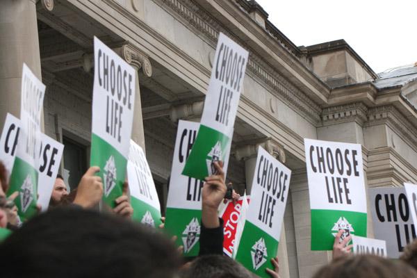 March for Life participants hold up Choose Life signs provided by the Knights of Columbus. (Malea Hargett photo)