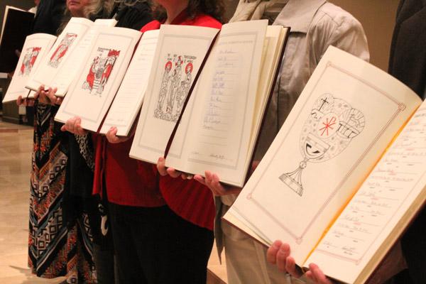 Names of candidates and catechumens are displayed in the Book of the Elect. More than 44 parishes across the diocese are ushering in new members to the Church.  (Dwain Hebda photo)
