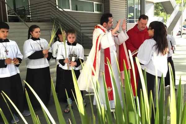 Father Ariel Ramirez, CM, with pastor Father George Sanders, blesses the palms to be used during the Spanish Mass on Palm Sunday, April 9 at St. Mary Church in Hot Springs. The parish recently expanded its ministry to Hispanics. (Judy Peters photo) Prints not available for this photo.