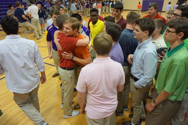 Aubrey Volpert gives a hug to a classmate after his signing day ceremony. Volpert will be a seminarian in the fall. (Aprille Hanson photo)