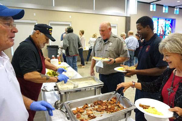 Firefighters Robert Haggard (left) and Chris Ingram are served breakfast by Knights of Columbus members at St. Mary Church during the breakfast for first responders on Sept. 11. (Aprille Hanson photo)  