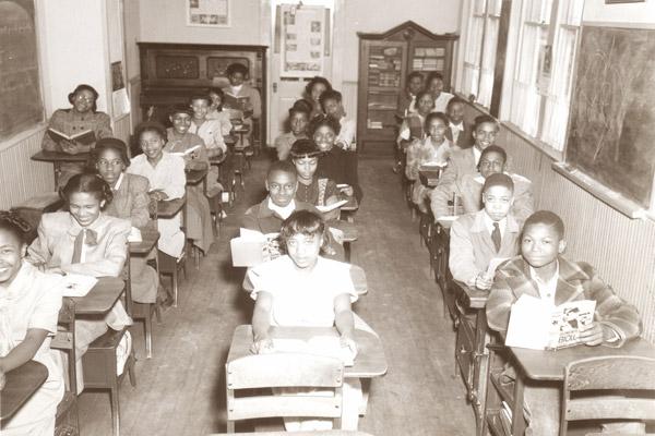 Students at St. Bartholomew School in Little Rock smile from their desks in this 1949 photo. The school was about a half-mile away from Central High School in Little Rock. (Diocese of Little Rock archives)