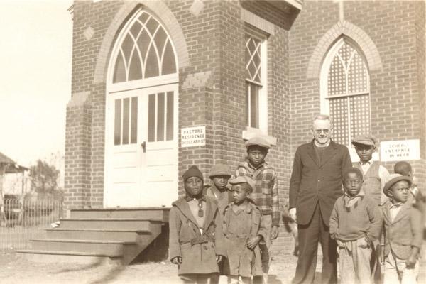 Father Joseph Haarman, SVD, stands with the first pupils of St. Augustine School in North Little Rock in September 1929. In the late 1950s, the Illinois-based Sisters of Christian Charity taught at the school. (Diocese of Little Rock archives)