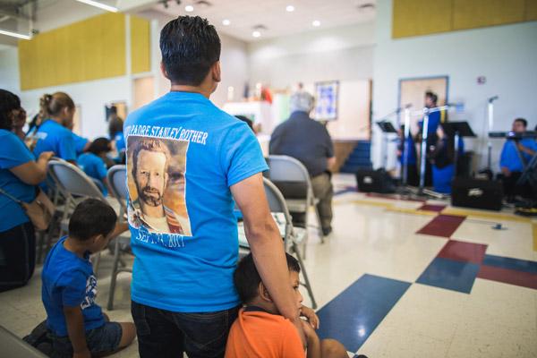 Many parishioners wore blue Blessed Father Stanley Rother T-shirts during the dedication Mass.  (Travis McAfee photo)