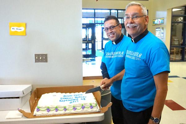 Bishop Taylor and Father Marquez-Munoz celebrate the dedication of the Blessed Stanley Rother Mission with a special cake. (Aprille Hanson photo)