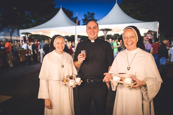 Sister Maria Catherine and Sister Joseph Andrew, OP, Mother of the Eucharist of Michigan, stop by Brewtober on their visit to the area. Newly ordained Father William Burmester enjoys their company. (Travis McAfee photo)