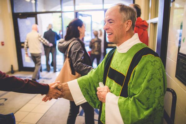 Deacon Bud Baldwin, who serves at St. Joseph Church in Fayetteville, greets parishioners following Mass Oct. 22. In September, he donated a kidney to his younger brother, Ben Baldwin of Maumelle. (Travis McAfee photo)