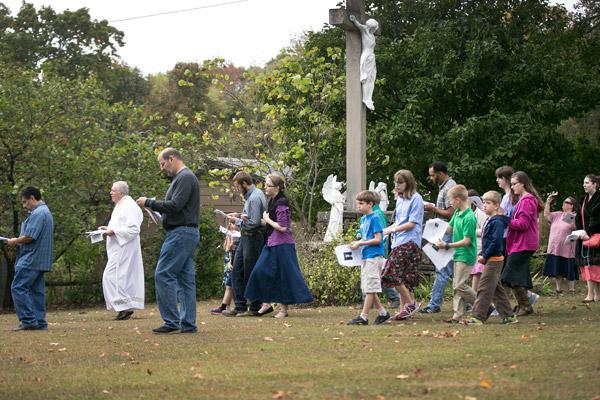 Pilgrims at the Shrine of Our Lady of the Ozarks in Winslow sing hymns as they walk to the fourth station, the statue of the Sacred Heart of Jesus, to recite the fourth glorious mystery of the rosary. (Karen Schwartz photo)