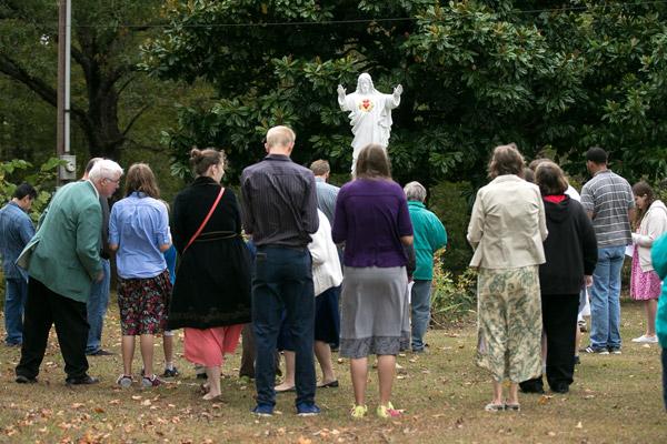 Pilgrims at the Shrine of Our Lady of the Ozarks recite the fourth glorious mystery of the rosary at the statue of the Sacred Heart of Jesus on Oct. 21. (Karen Schwartz photo)