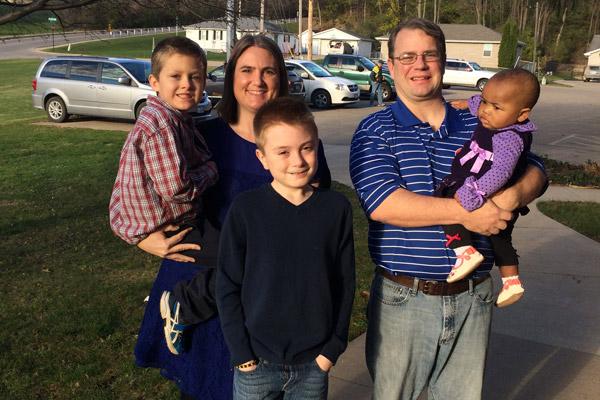 Melanie and Eric, of Iowa, stand with their sons Micah (left), Isaiah and daughter HopeAnn. Micah and HopeAnn are adopted. 