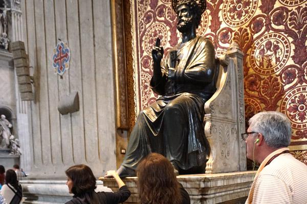 Arkansas pilgrims rub the foot of the 500-year-old bronze statue of St. Peter in St. Peter’s Basilica in Rome Oct. 31. It is traditional to touch or kiss the foot when visiting the basilica. (Malea Hargett photo)