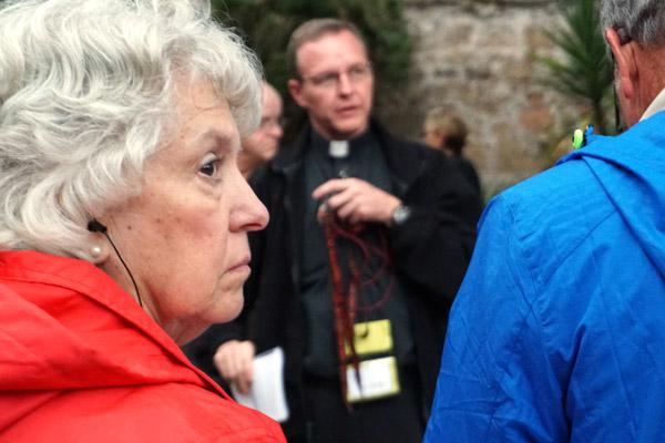 Debbie Vaughn of Lake Village listens to Father Erik Pohlmeier prepare pilgrims Nov. 3 before an afternoon retreat of mediation, prayer and confession at Tre Fontane (Three Fountains) Abbey, site of where St. Paul was beheaded in Rome. (Malea Hargett photo)