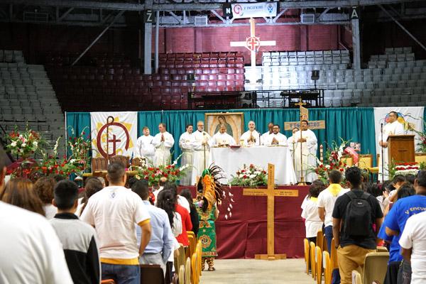 Eight priests concelebrated Mass with Bishop Taylor in Barton Coliseum. (Malea Hargett photo)