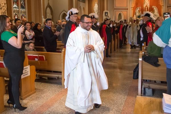Father Rubio beams a smile as he walks out of the Cathedral of St. Andrew at the conclusion of his ordination Mass Dec. 16. (Bob Ocken photo)