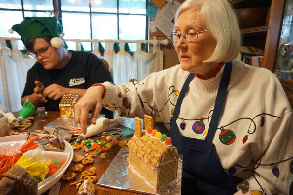 Nancy Frevert, of Little Rock, has been coming to the Lefflers to make Christmas cookie houses for more than 20 years. On Dec. 21, she was building a church. (Aprille Hanson photo)