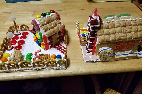 Two of the completed cookie house masterpieces from Dec. 21 sit on the counter, ready to be displayed or eaten. 