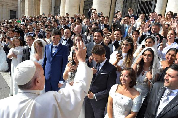 Pope Francis greets newly married couples during his general audience in St. Peter's Square at the Vatican in this Sept. 30, 2015, file photo. In 2016 the pope released a major document, "Amoris Laetitia," which focused on love in the family. (CNS photo/L'Osservatore Romano)