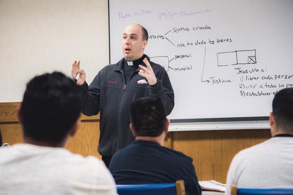 Father William Burmester, associate pastor of St. Raphael Church in Springdale, teaches Spanish-speaking students about the Ten Commandments March 18. (Travis McAfee photo)