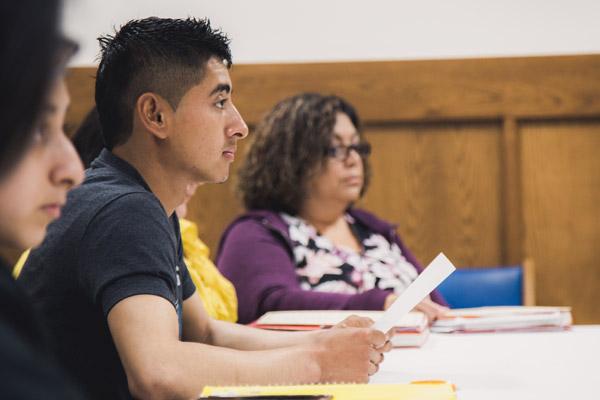 José R. Salazar and Reina Rodríguez (back, right) listen during an RCIA class in Springdale March 18. Dozens of Latinos are moving from “cultural” Catholicism to receiving their sacraments this Easter. (Travis McAfee photo)