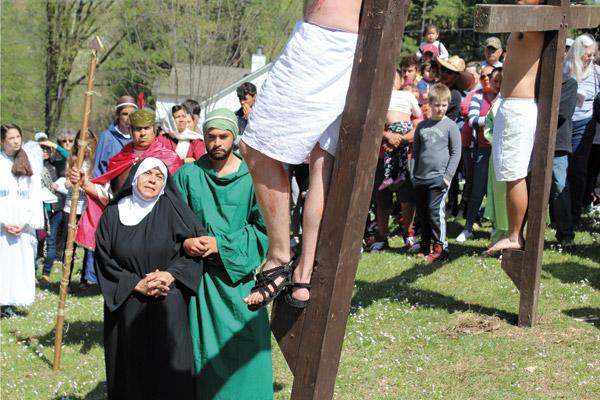 Carmen Sanchez Moreno as Mary and Armando Perez as John watch Jesus, played by Samuel Brown, die on the cross during the Live Stations of the Cross at Our Lady of Fatima Church in Benton March 30. The parish called it a “spiritual pilgrimage of prayer.” (Dwain Hebda photo)