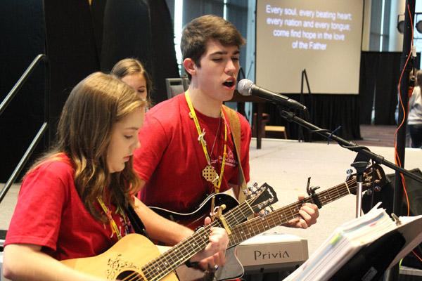 Chandler Vail and Cecelia Rech, both of Christ the King Church in Little Rock, lead praise and worship music during the 2018 Catholic Youth Convention. (Dwain Hebda photo)