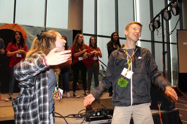 Youth Advisory Council members Claire Hollenbeck of Fort Smith and Collin Gallimore of Hot Springs get attendees up and dancing during Saturday morning activities during the state youth convention. (Dwain Hebda photo)