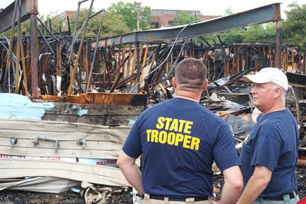 Arkansas State Police Sgt. Mike Dawson (right) discusses the fire that destroyed the Arkansas Pregnancy Resource Center in Little Rock with ASP Cpl. Josh Berry on May 21. (Aprille Hanson photo)