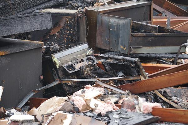 A charred ultrasound machine donated in 2014 by the Knights of Columbus sits among debris from the May 20 Arkansas Pregnancy Resource Center fire. (Aprille Hanson photo)