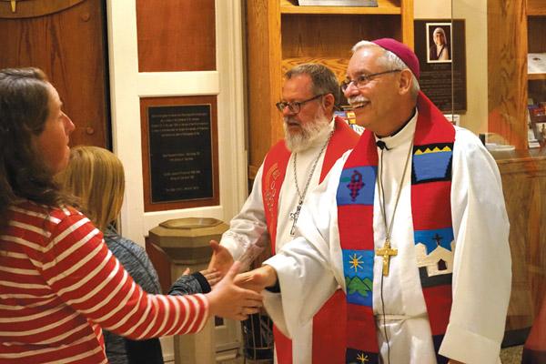 Bishop Anthony B. Taylor (right) and Bishop Michael Girlinghouse of the Arkansas-Oklahoma Synod of the Evangelical Lutheran Church in America (ELCA) shake hands with people after the Oct. 30 prayer service at the Cathedral of St. Andrew in Little Rock commemorating the 500th anniversary of the Protestant Reformation. (Aprille Hanson / Arkansas Catholic file)