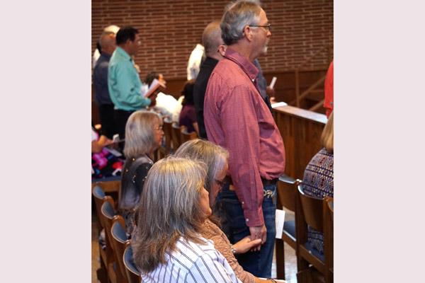 John Birmingham and his wife Anne, of St. Jude Church in Jacksonville, hold hands during the candidacy rite. (Malea Hargett photo)