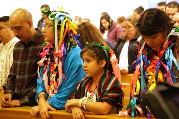Juan and Luz Chavez, (left) their daughter Marialy Chavez and Juan’s sister Maria Chavez pray during the Our Lady of Guadalupe Mass Dec. 8 at Holy Spirit Church in Hamburg. (Malea Hargett photo)