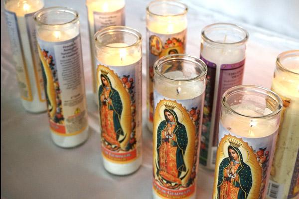 Vigil candles for Our Lady of Guadalupe burn during the fiesta. (Malea Hargett photo)