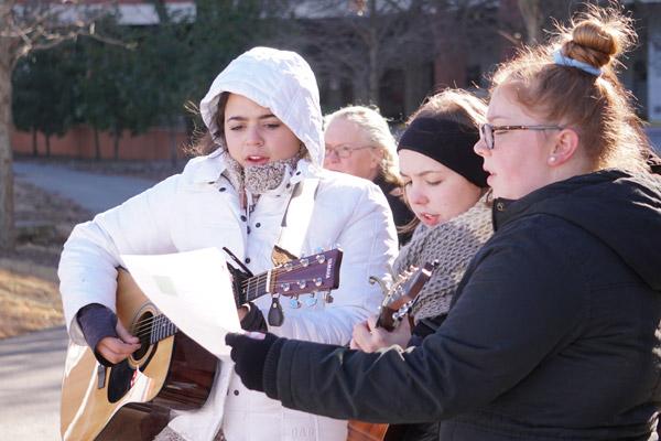 Members of Team Jesus bundle up while leading the participants in a song at the first station of the Eucharistic Procession for Life. (Malea Hargett photo)