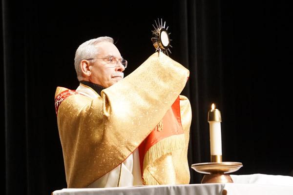 Bishop Taylor elevates the monstrance during the Benediction before the Mass for Life at Robinson Center Performance Hall. (Malea Hargett photo)