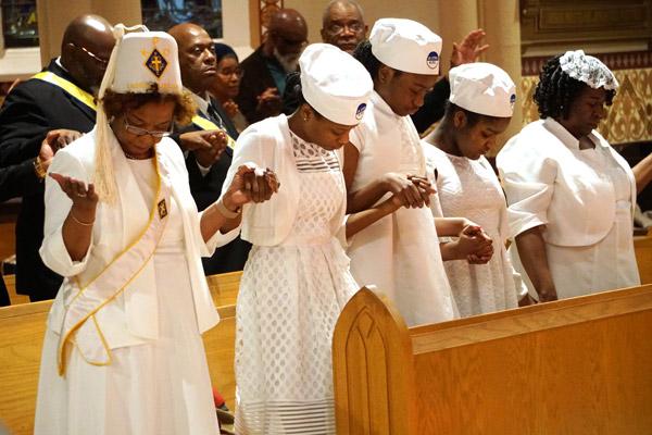 Junior Daughters of St. Peter Claver pray the Our Father during the MLK Mass Jan. 19. (Malea Hargett photo)