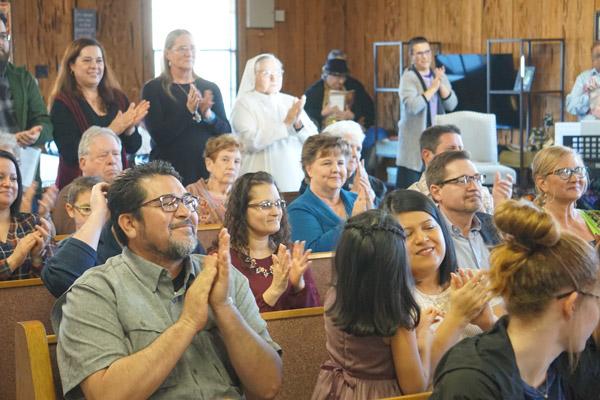 Congregants applaud after Bishop Taylor establishes an official Catholic community of Greenbrier during the March 16 Mass. The Mass was held eight days ahead of St. Oscar Romero’s March 24 feast day. (Aprille Hanson photo)