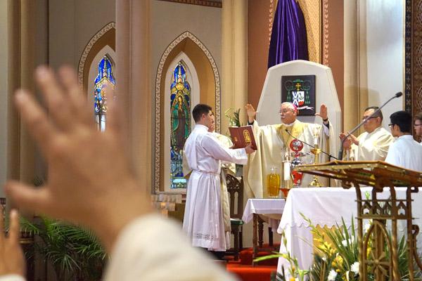 Bishop Taylor, along with all the priests at the Chrism Mass on April 15, extends his hands to consecrate the chrism oil, which is used in sacraments of baptism, confirmation and holy orders, as well as to consecrate a new church and altar. (Aprille Hanson photo)