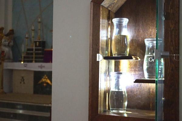 The ambry at St. Patrick Church in North Little Rock, built last year, displays the three types of holy oils kept on hand for sacraments throughout the year: chrism, oil of catechumens and oil of the sick. (Aprille Hanson photo)