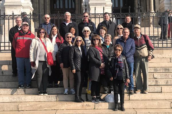 Twenty-two pilgrims from the Diocese of Little Rock, including three diocesan priests, pose for a photo April 11 on the steps of the Sacre Coeur, also known as the Basilica of the Sacred Heart on Montmartre in Paris. (Malea Hargett photo)