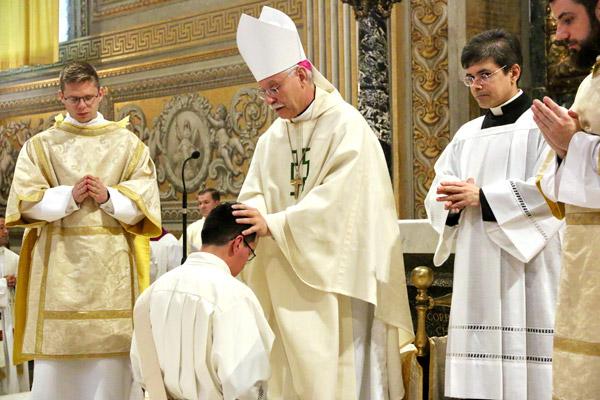 Bishop Anthony B. Taylor lays his hands on Father Amaro to receive the strength of the Holy Spirit. (Denis Nakkeeran photo, Pontifical North American College)