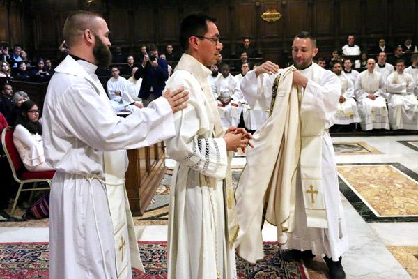 Father Stephen Gadberry (rights), of Batesville, vests his friend and fellow priest Father Amaro along with Father Jeff Hebert of Conway during his ordination in Rome. (Denis Nakkeeran photo, Pontifical North American College)