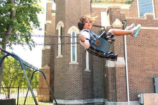 PreK student Nariah Delaney flies as high as the swing will take her during recess. Delaney and her St. Edward classmates and teachers said goodbye to the 134-year-old school May 24. (Dwain Hebda photo)